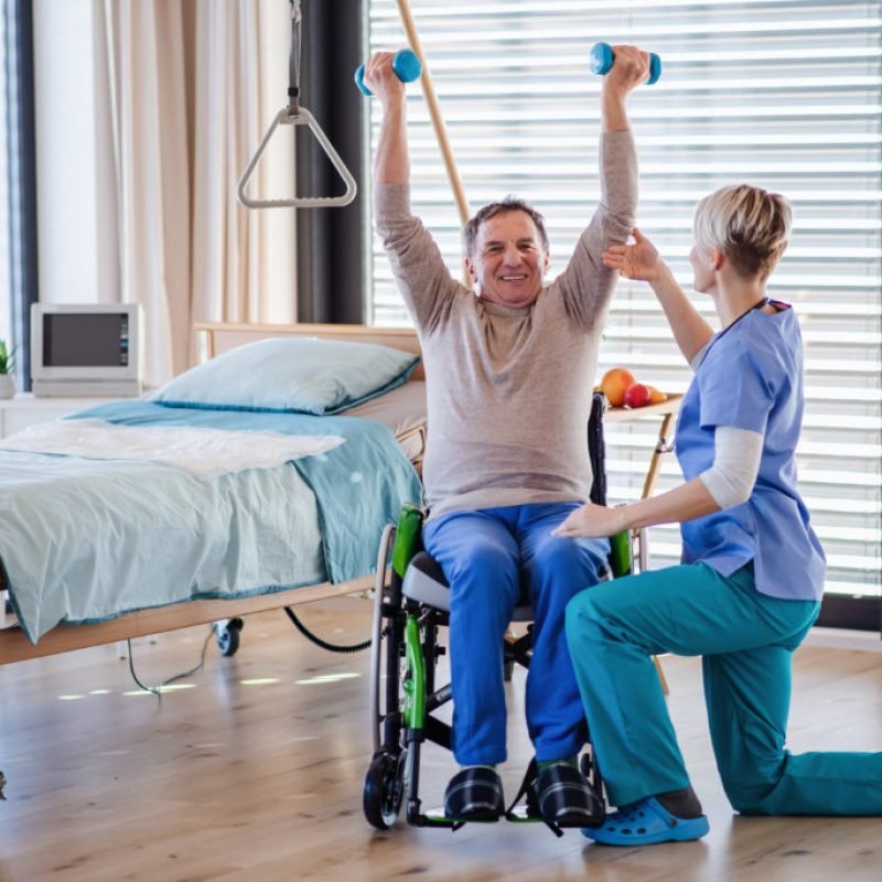 A healthcare worker and senior patient in hospital, physiotherapy concept.